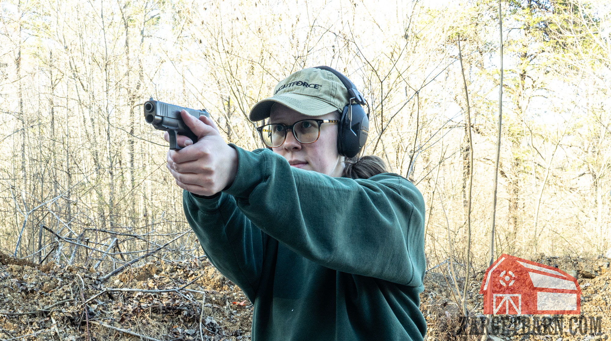 the author shooting with iron sights