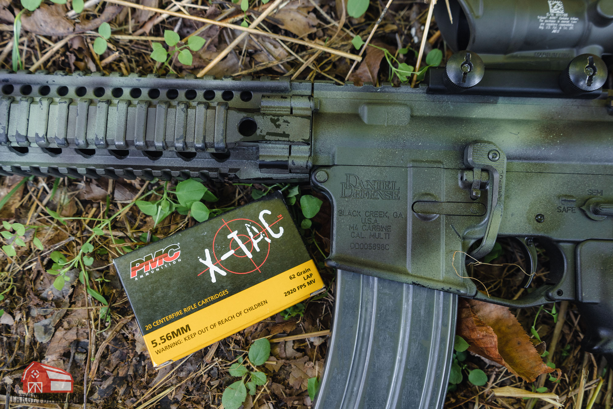 an ar-15 next to a box of 5.56 ammo